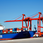 국제무역이론과실무 - Global Trade and Specialization**

"A bustling international port scene with cargo ships, cranes, an...